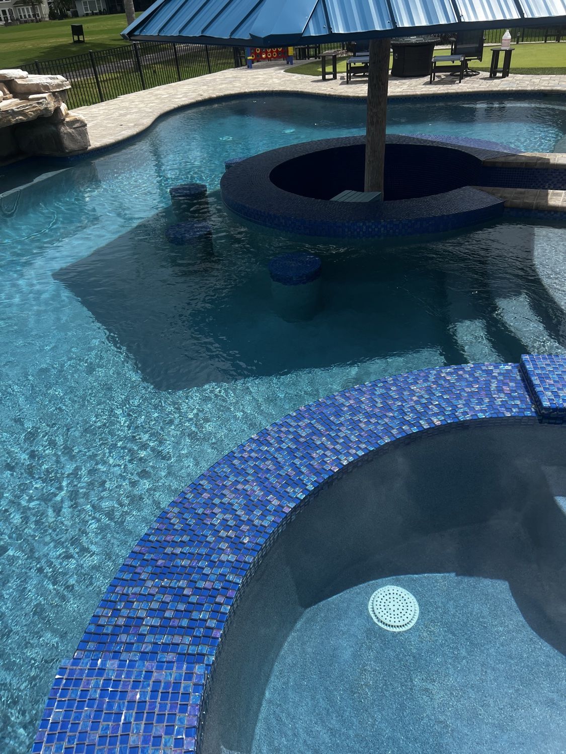 Clear resort-style pool surrounding a swim-up bar