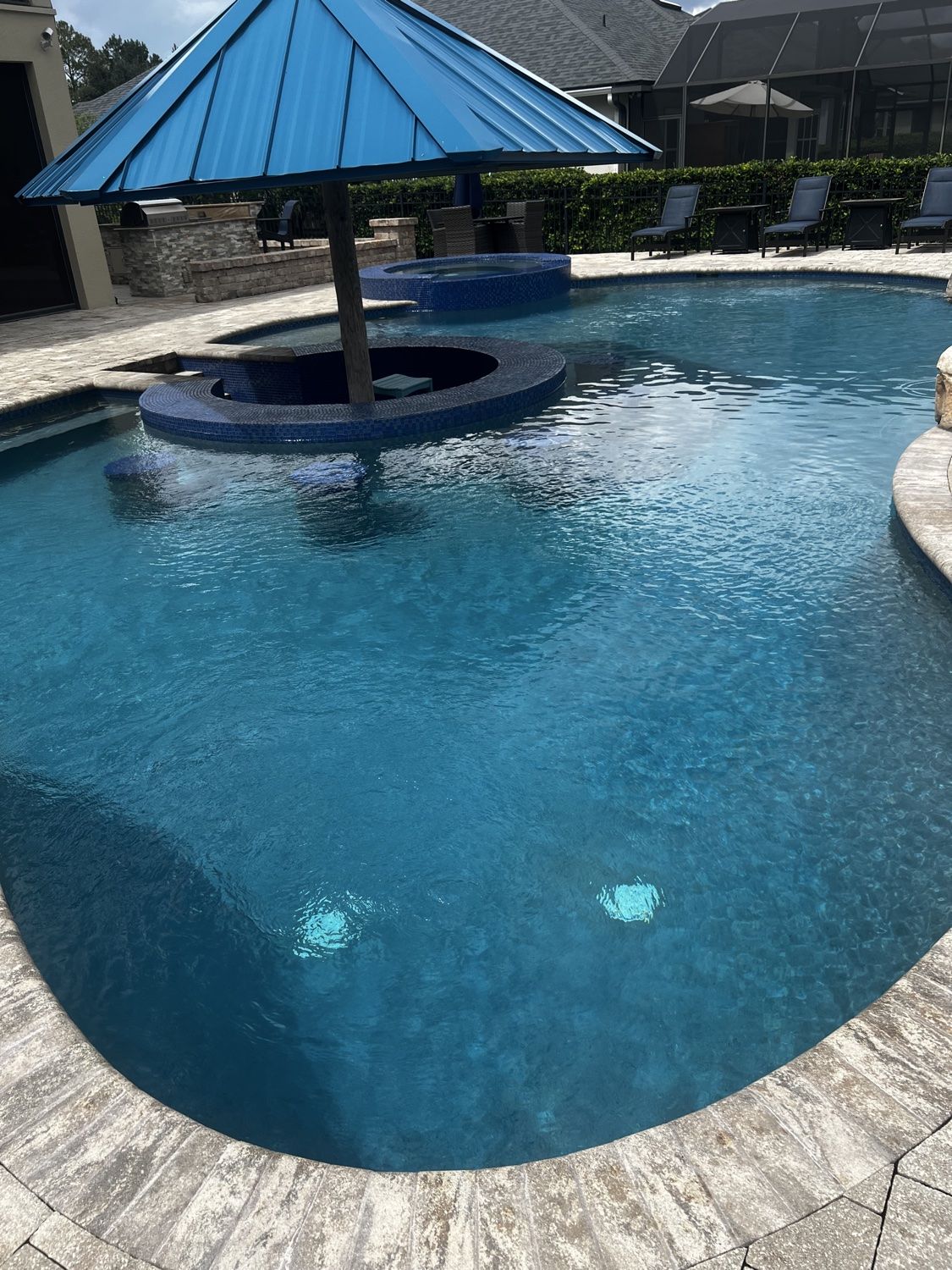 Finished resort-style swimming pool with clear blue water