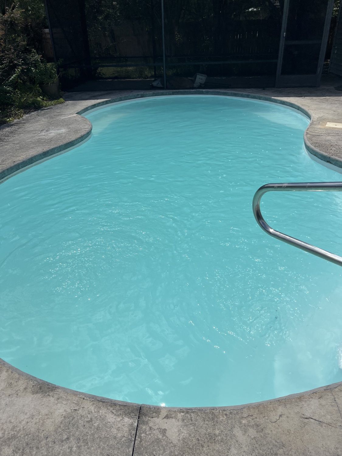 Same pool restored to clear blue water after algae removal